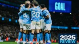 Manchester City players celebrate a goal at Etihad Stadium with '2025 Review' displayed on screen.