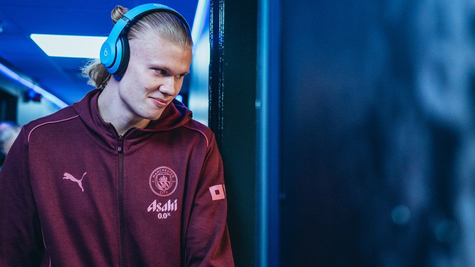 HAPPY HAALAND : Erling arrives with a smile, fresh from signing his new 10-year deal with City.