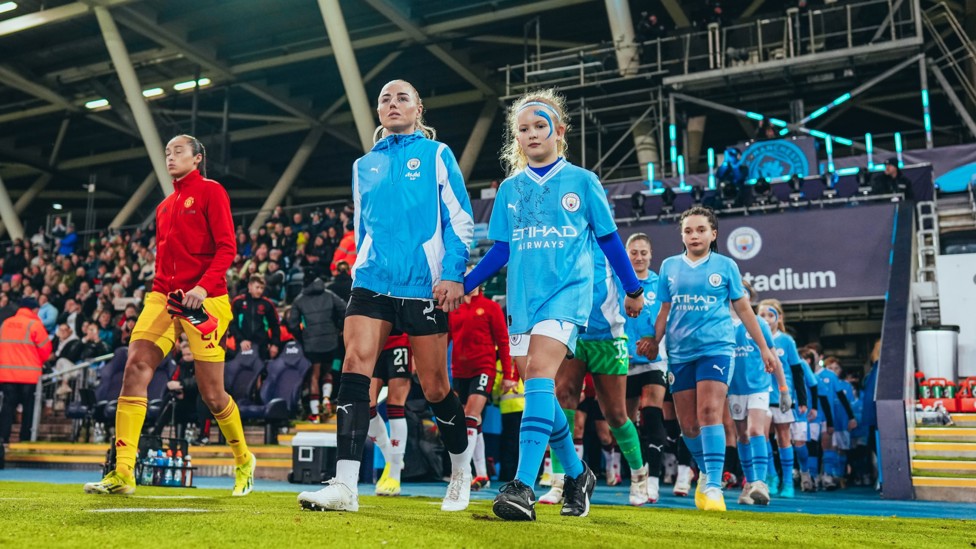 HERE WE GO  : City and Manchester United's players enter the field.