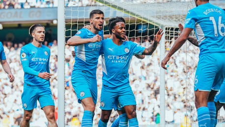 STERLING JOB: Raheem is congratulated by his teammates after his 19th minute goal.