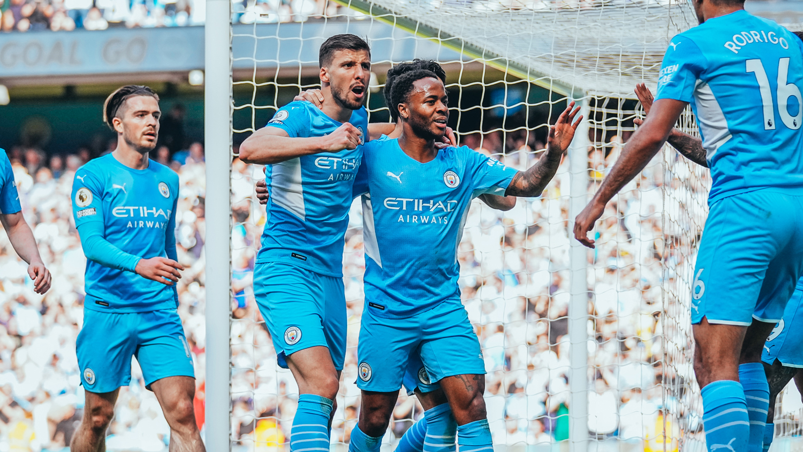 STERLING JOB: Raheem is congratulated by his teammates after his 19th minute goal.