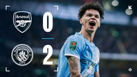Scoreboard image showing Arsenal 0 and Manchester City 2 in a Carabao Cup match with a blurred player.