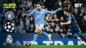 Action shot of Manchester City and Real Madrid players during a UEFA Champions League match. Includes Manchester City and Real Madrid logos.