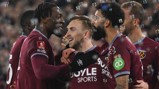 West Ham players celebrate in maroon jerseys with bubbles floating. FA Cup patch visible.
