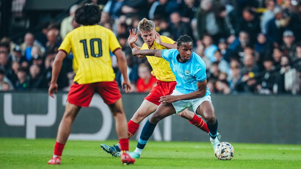 ACTION SHOT : Stephen Mfuni shrugs off Watford's players to help City win 1-0 in the FA Youth Cup semi-final.