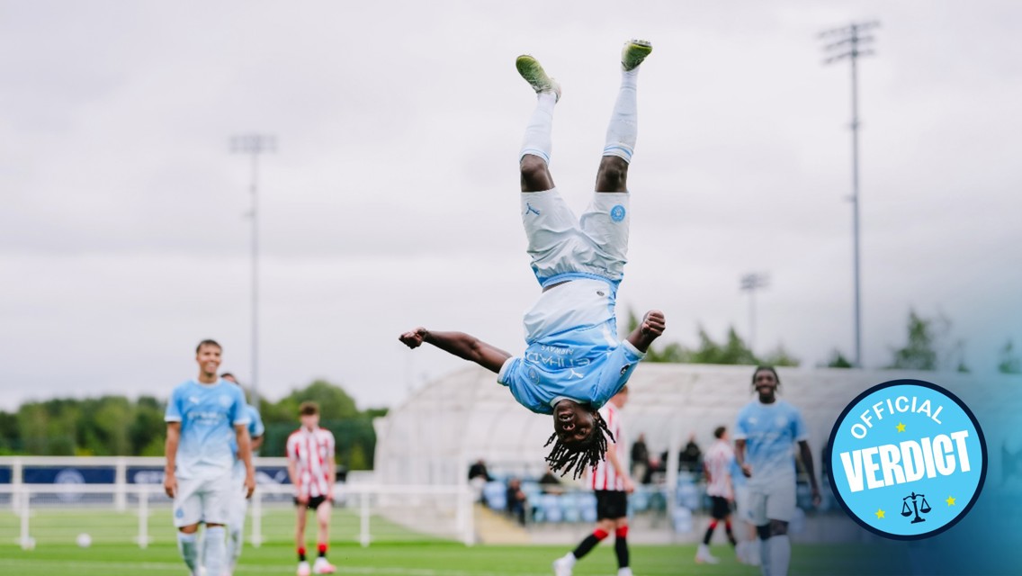 A soccer player in a light blue kit performs a backflip on a field, celebrating a goal. Other players and spectators in the background. 'Official Verdict' text on the image.