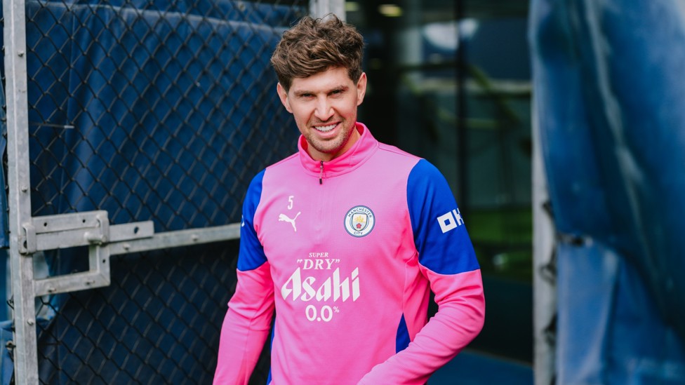 SUPER STONES : Our classy centre-half all-smiles as he makes his way onto the training pitch