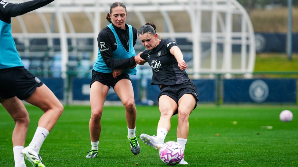 FIGHTING SPIRIT: Lily Murphy fends off pressure from Naomi Layzell