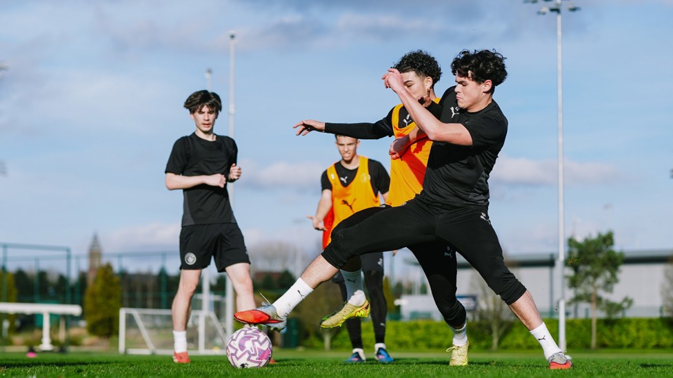 STUCK IN: Teddie Lamb tries to win the ball off Kylan Midwood
