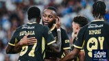 Manchester City players in black and gold kits celebrating during the Asia Tour 2026, with 'Experience Abu Dhabi' branding and the Asia Tour '26 logo visible.