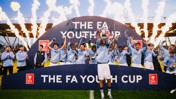 Manchester City Youth Team celebrating their FA Youth Cup victory with fireworks in the background.