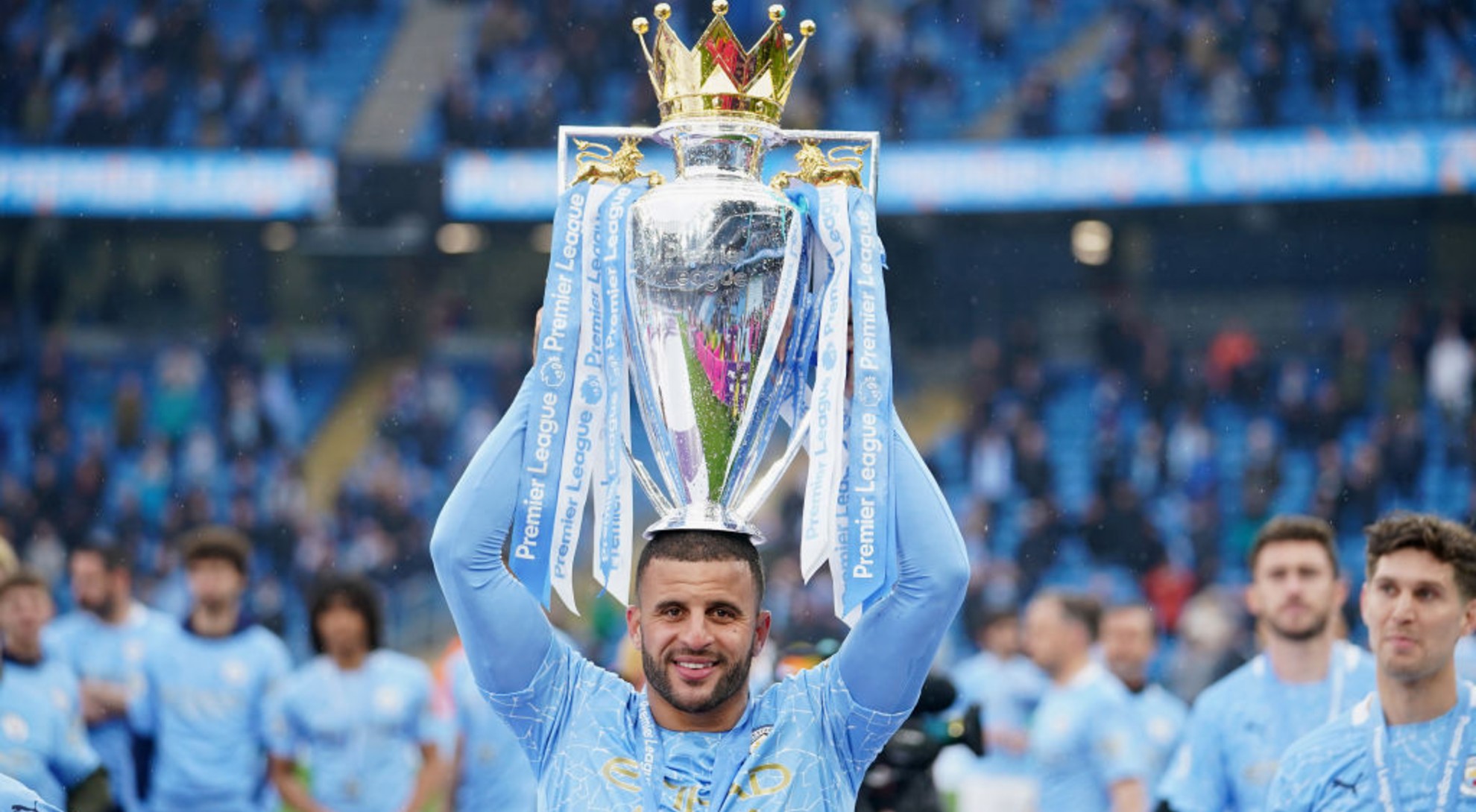 WINNER: Walker proudly holds the Premier League trophy aloft