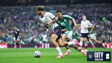 Players from England and Mexico competing for the ball during a soccer match at the World Cup. The event is sponsored by Manchester City and FIFA.