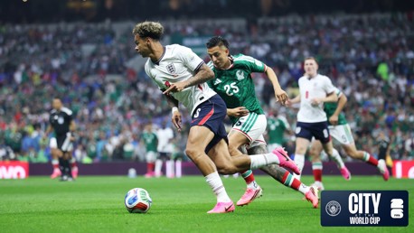 Players from England and Mexico competing for the ball during a soccer match at the World Cup. The event is sponsored by Manchester City and FIFA.