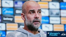 A person in a grey hoodie at a press conference with a background of sponsor logos. The image features a 'Manager's Preview' graphic with the Asahi logo.