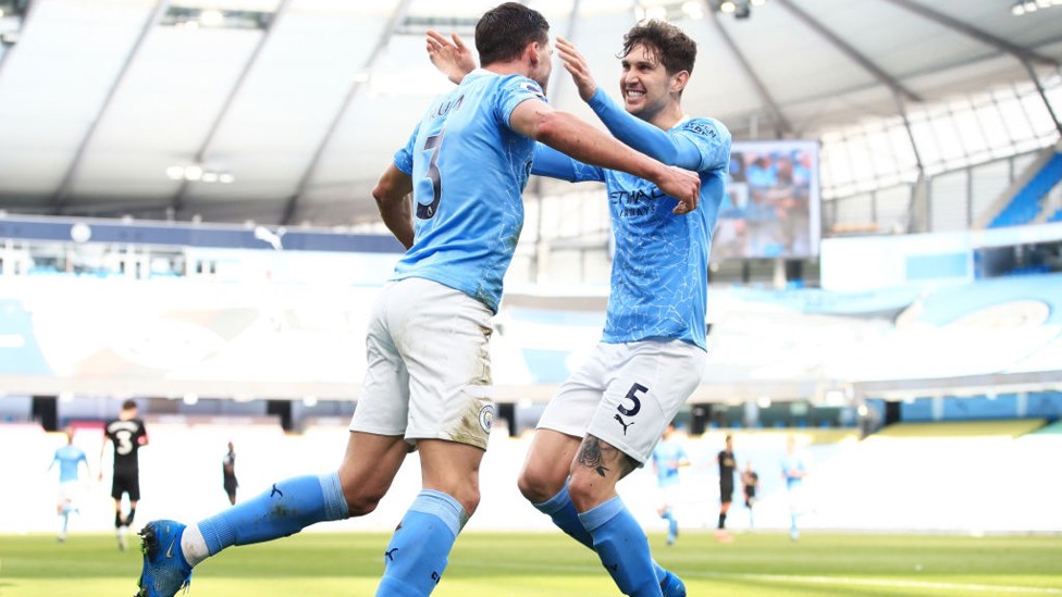 BROMANCE : Stones is the first to congratulate his defensive partner Dias after his goal.