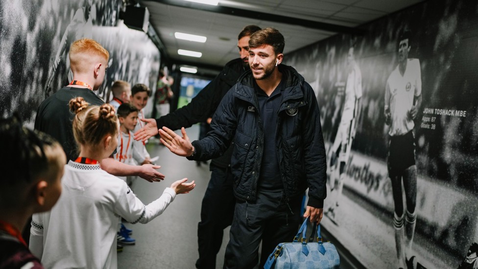 HIGH FIVES : Nico and Donnarumma greet some mascots on the way to the away dressing room.