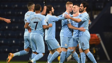 PERFECT START: The players rush over to congratulate Gundogan after his accurate finish.