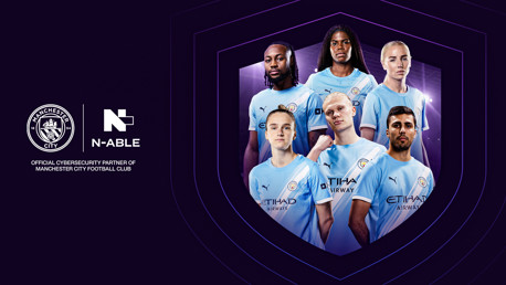 Manchester City players in home kit with N-able logo. Partnership announcement as official cybersecurity partner. Man City and N-able logos visible.