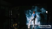 A person in a Manchester City football kit poses with a football in a dimly lit room. The text 'Welcome to City Niamh Charles' is displayed in the corner.