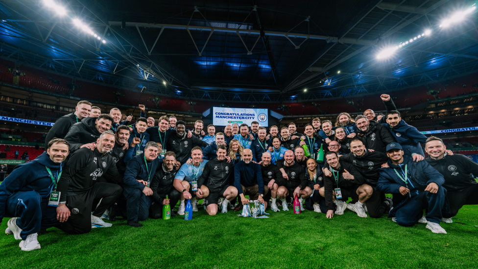 BACKROOM STAFF : The unsung heroes pose with the trophy.