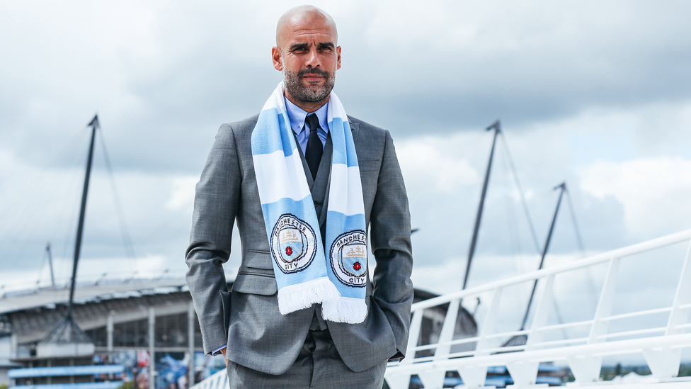 CLUB COLOURS : Guardiola wears City's famous blue and white for the first time