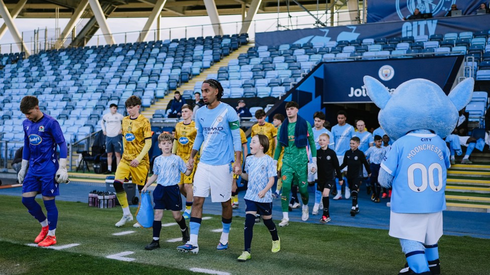 LEADING THE TEAM : Captain Kaden Braithwaite leads the team out onto the pitch. 