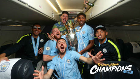 SOAR POINT: The City players celebrate their title success on the flight home from Brighton