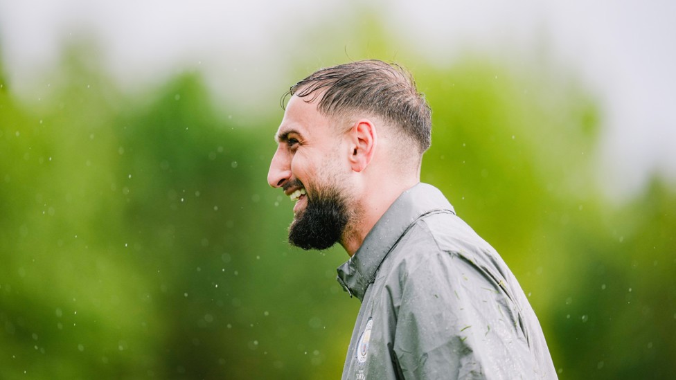 WELCOME TO MANCHESTER : Gianluigi Donnarumma is greeted by usual wet northern weather during his first session. 