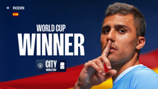 Image features a person posing with a finger to their lips. Text on the image reads 'World Cup Winner' with a Spanish flag and 'Rodri' text. Manchester City branding is present.