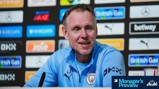 A person in a Manchester City jacket at a press conference with sponsor logos in the background. A sign at the bottom reads 'Manager's Preview' by Asahi Super Dry.