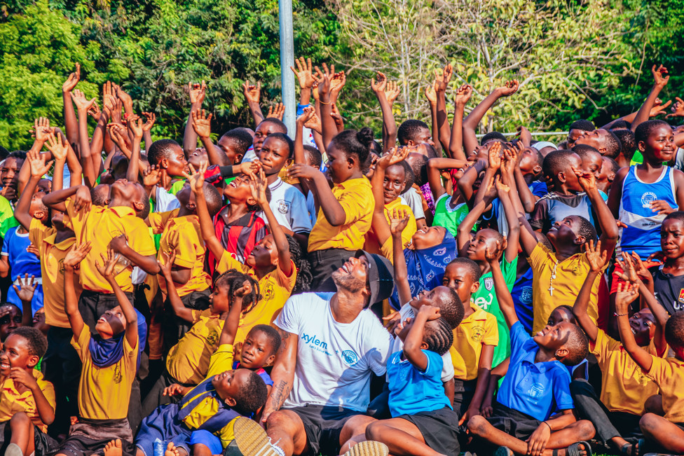 Joleon and local children celebrate at the community football festival 