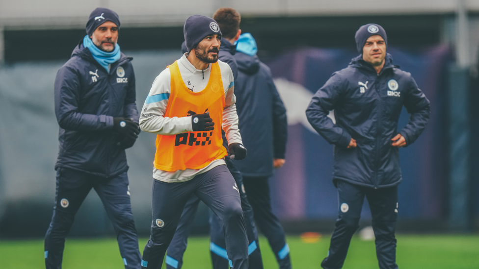 Gundo warms up under the watchful eye of Pep and his coaches...