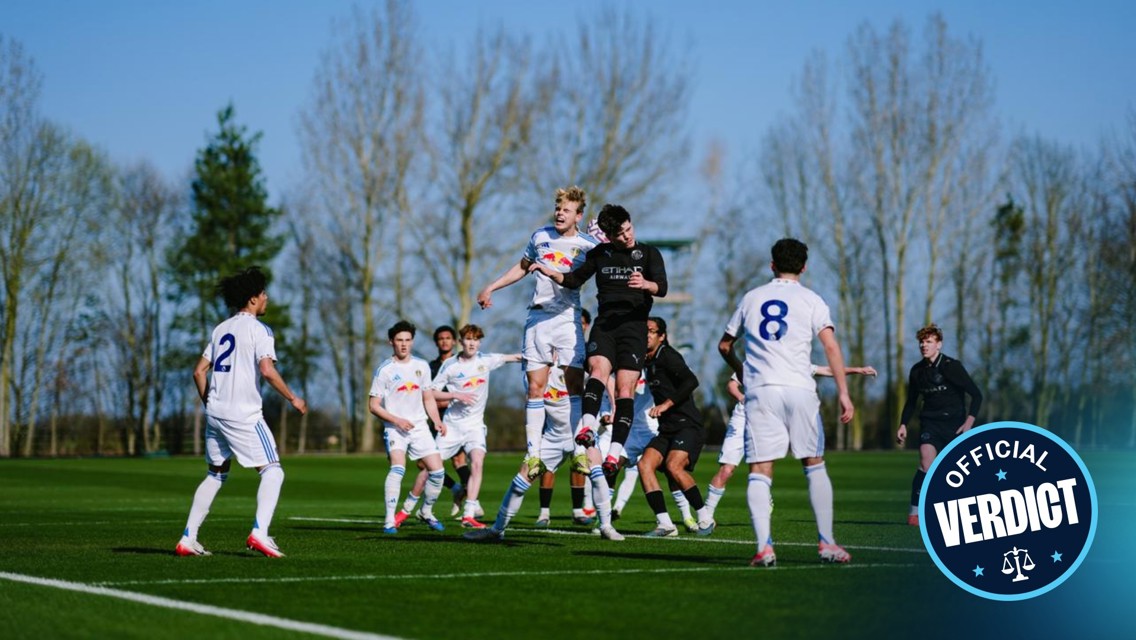 Soccer players compete in a match, while others watch. Players wear kits with Red Bull and Etihad sponsors. Some are jumping to head the ball. An 'Official Verdict' emblem is displayed in the corner.