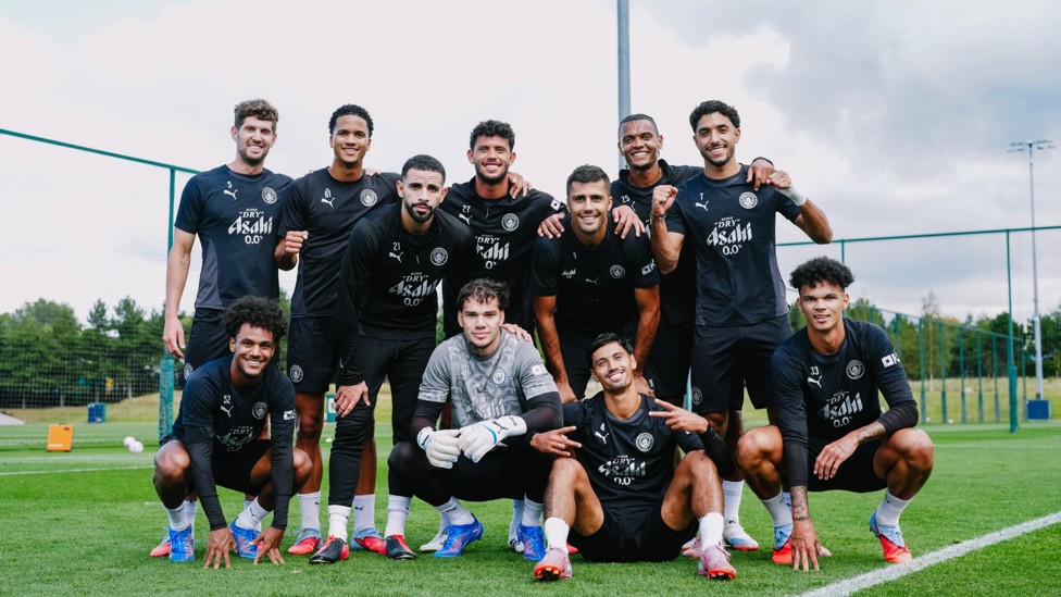 ALL TOGETHER NOW : The players pose for a photo after the session