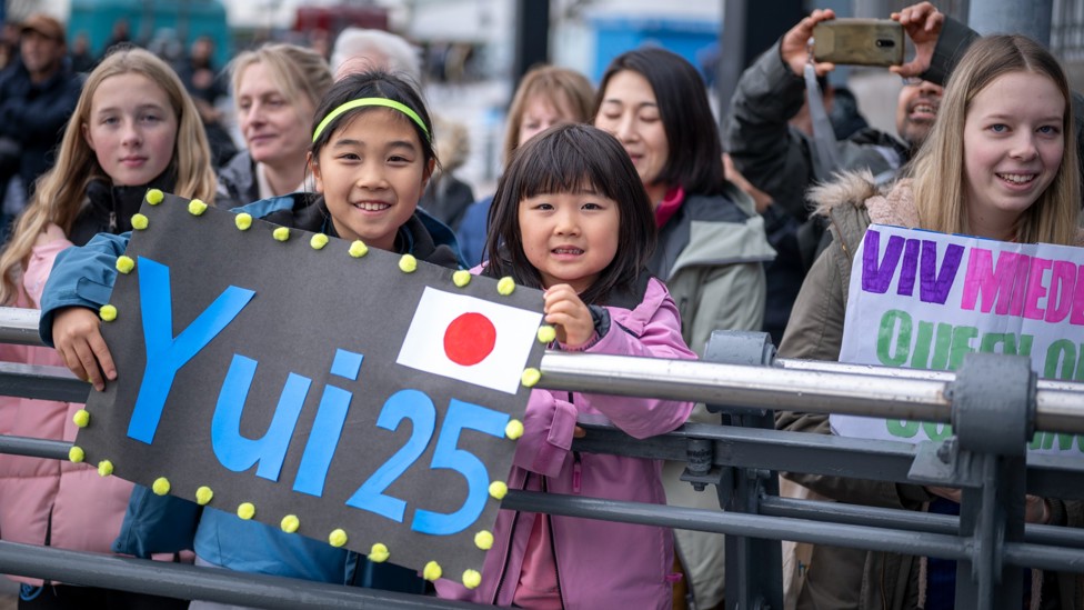 NUMBER ONE FANS: Two young girls holding a Yui Hasegawa sign pre-match
