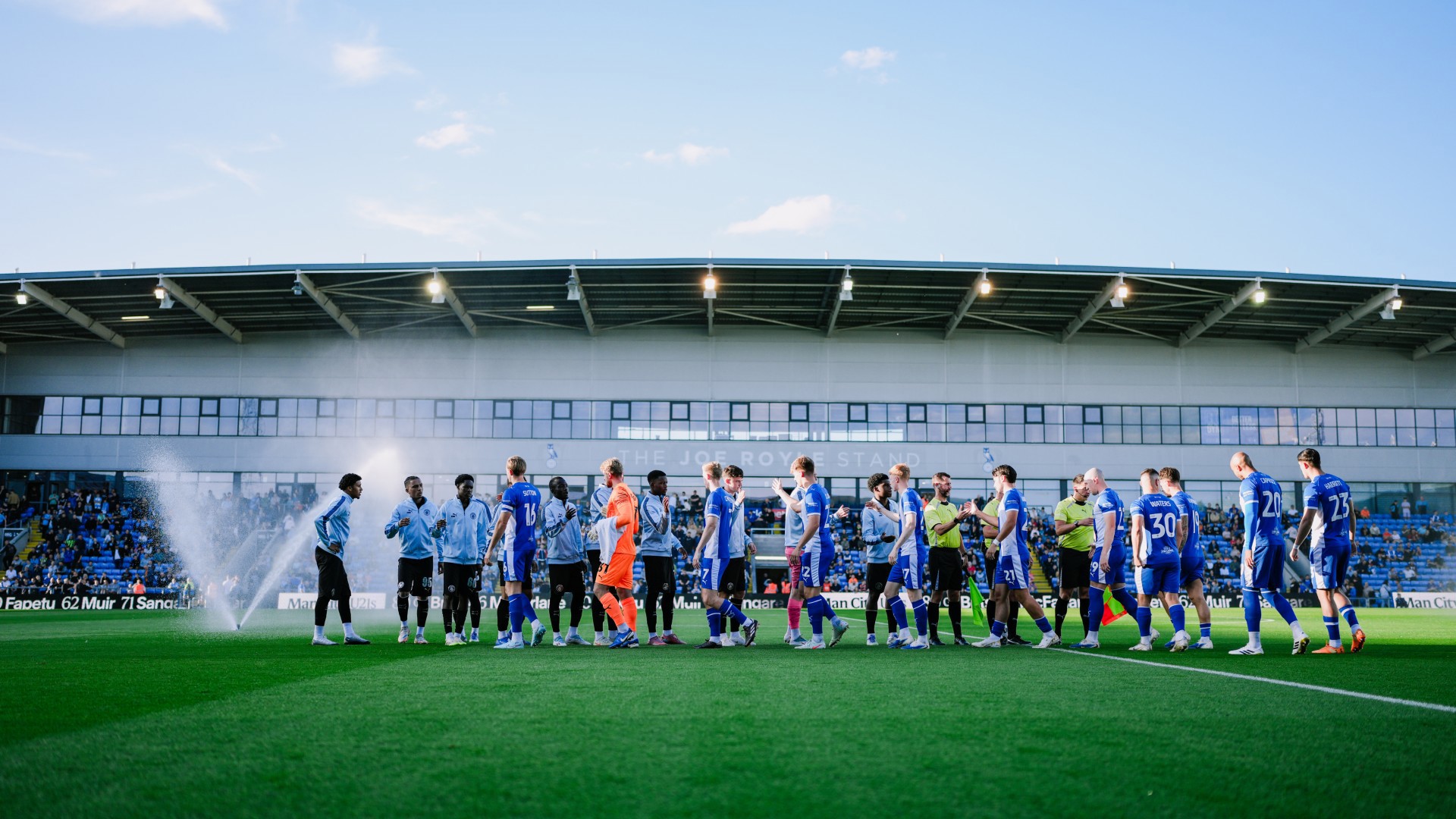 READY FOR ACTION : City shake hands with Oldham ahead of kick-off. 