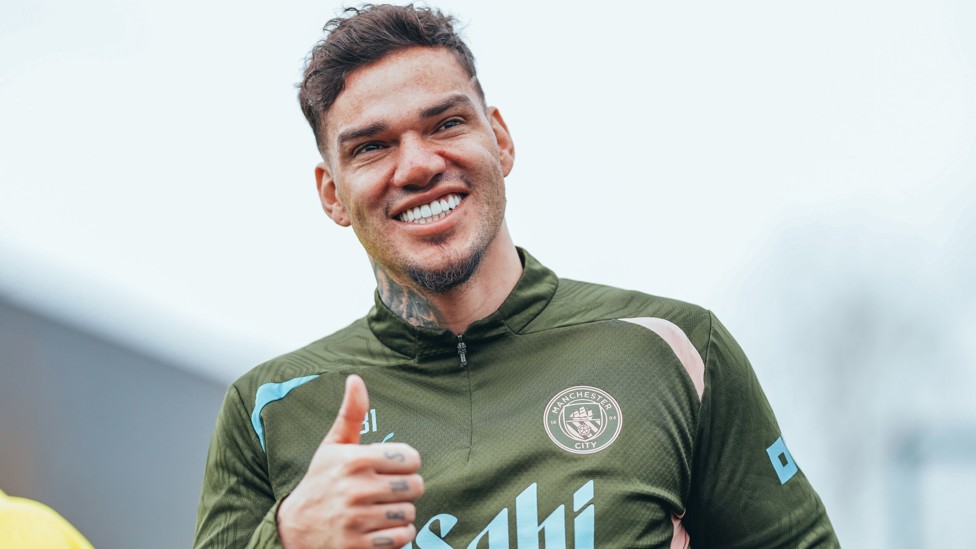 THUMBS UP : Ederson looks happy to be back in Manchester