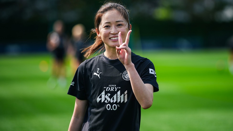 ALL SMILES  : Risa Shimizu spots our camera.