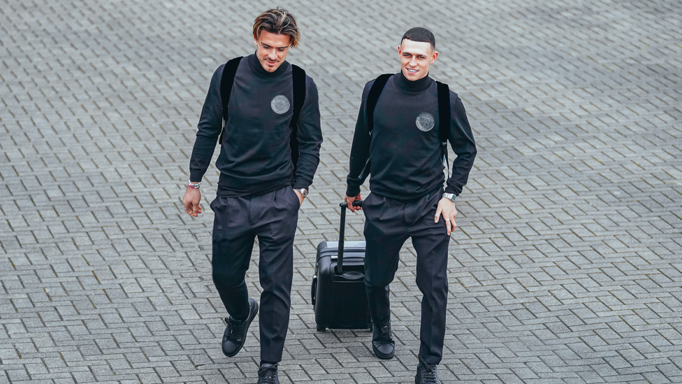 ENGLAND BUDDIES : Jack Grealish and Phil Foden have a chat on their way across the tarmac