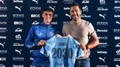 Two men holding a Manchester City jersey with 'Foden 2030' printed on the back, indicating a contract extension. Logos and sponsors visible in the background.