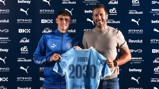 Two men holding a Manchester City jersey with 'Foden 2030' printed on the back, indicating a contract extension. Logos and sponsors visible in the background.