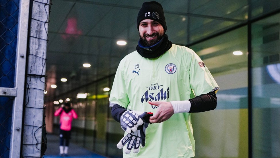 SMILING STOPPER : Gianluigi Donnarumma heads out for the final training session of the year