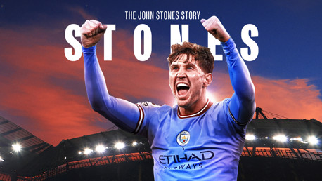 A football player in a Manchester City kit with raised arms, with 'The John Stones Story' and 'STONES' text above. The background shows a stadium and a sunset sky.