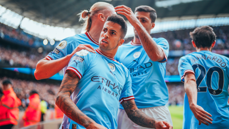 CELEBRATE: Cancelo feels the love after his opener.