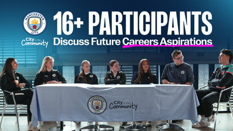 A group of 16+ participants from Manchester City are seated at a table discussing future career aspirations as part of the City in the Community initiative.