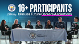 A group of 16+ participants from Manchester City are seated at a table discussing future career aspirations as part of the City in the Community initiative.