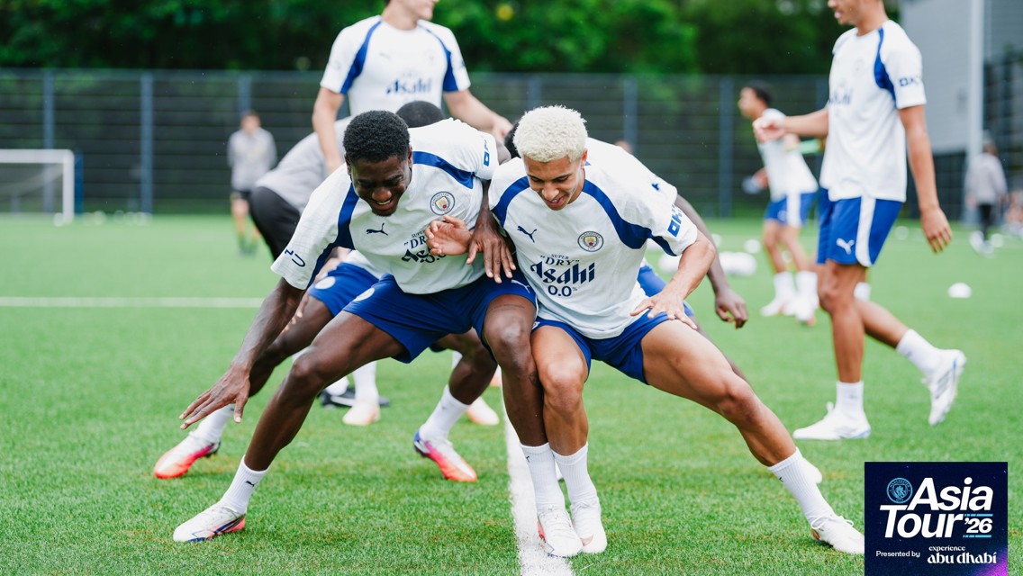Manchester City players in training session during Asia Tour '26. They are wearing Puma training kits, and the image includes a logo in the bottom corner.