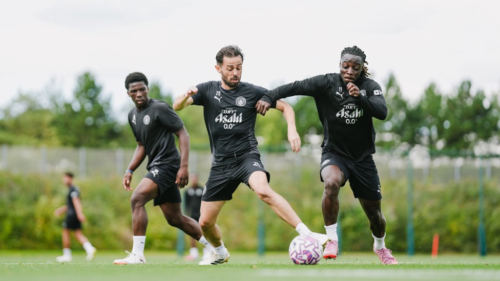 BATTLE  : Bernardo Silva and Jeremy Doku contest the ball. 