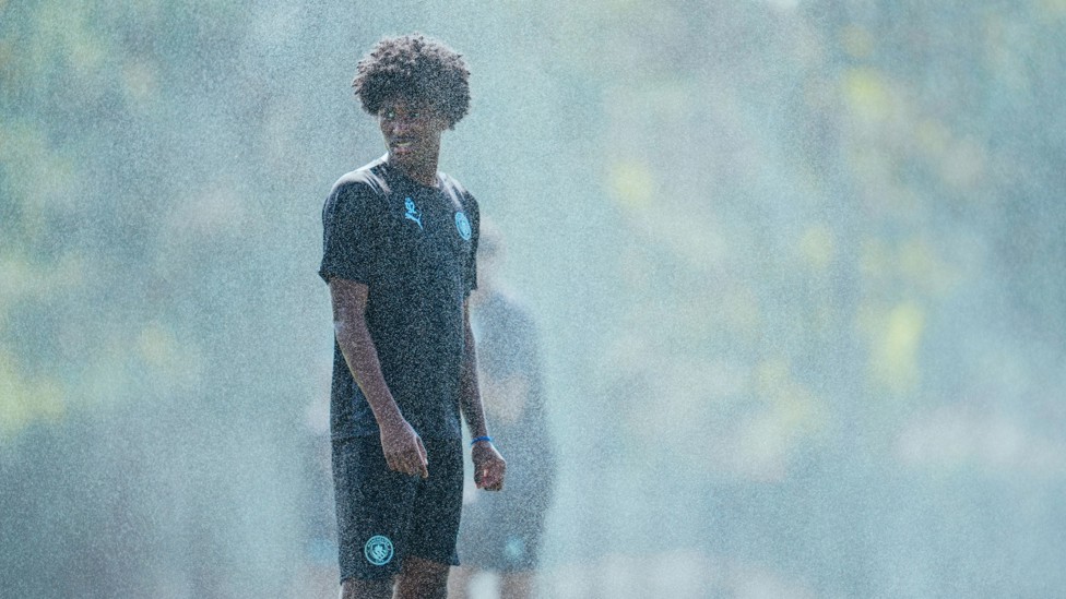 SPRINKLE AND SHINE : Reigan Heskey gets a little drizzle. 